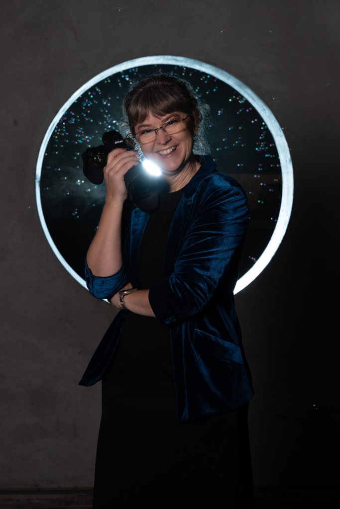 Photo of a Woman holding a camera 
